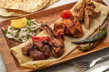 Mixed Grill served in a dish isolated on grey background side view of fastfood