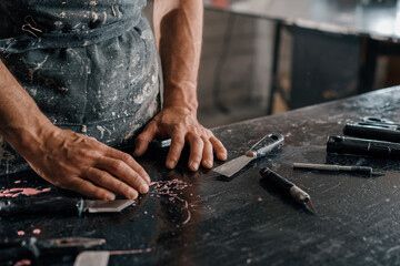 Close-up: tired hands of men painter sculptor artisan in the art workshop