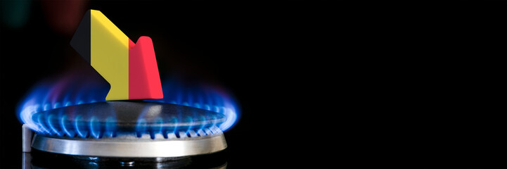 Decreased gas supplies in Belgium. A gas stove with a burning flame and an arrow in the colors of...