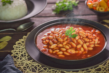 Arabic Cuisine; Middle Eastern traditional white beans in tomato sauce. Served with white rice and oriental pickles.