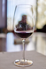 glass of red wine in the foreground with the background out of focus in a winery in Mendoza Argentina. Wine tasting. Selective focus