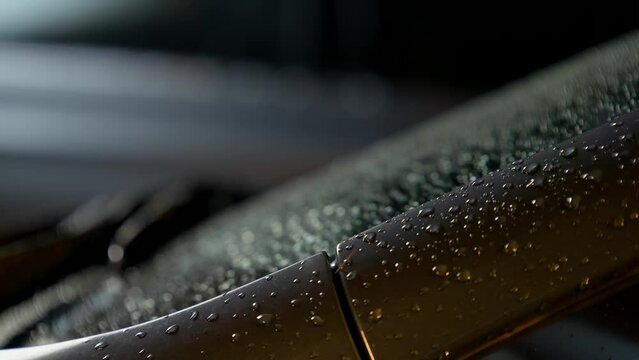 Still Raindrops on the Windshield of a Car an Night.
