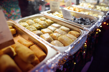 Hot food on Krakow Christmas market. Gabbage rolls, pancakes and other semi-finished products . Traditional european cuisine.