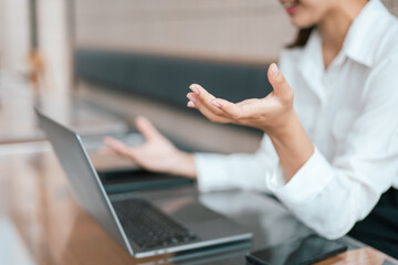 Young business women working and typing on laptop with happy and smile face on office spec.