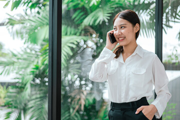 Business woman working on smartphone in office space.