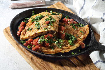 Simple hearty breakfast: homemade omelette with mushrooms, beans and parsley