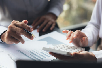 The sales department is having a monthly summary meeting to bring it to the department manager, they are verifying the correctness of the documents that are prepared before bringing in to the manager