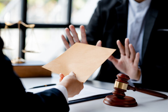 Individuals are giving bribes to officials in order to commit corruption in lawsuits, illegal actions by law enforcement by paying bribes to officials are illegal and unlawful. Fraud concept.