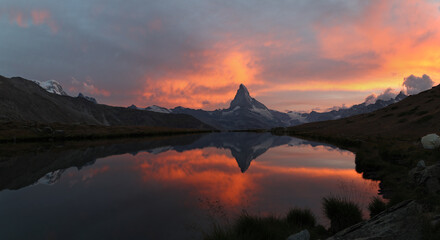 Panorama of sunset with dramatic alpenglow at the high mountain lake Stelisee with the famous Alps peak Matterhorn, Zermatt, Switzerland