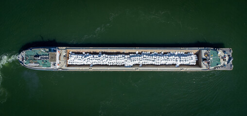 Fototapeta na wymiar Ship making a turn on Danube River near Vidin, Bulgaria shot with a drone from above