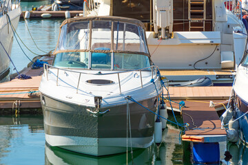 Fototapeta na wymiar Yacht cutter boat on the pier in the sea bay.