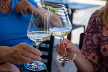 Drinking of txakoli or chacolí slightly sparkling very dry white wine produced in Spanish Basque Country, served in restaurant in Getaria, Spain