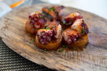 Spanish starter in fish restaurant in Getaria, grilled octopus with roasted potatoes and paprika, Basque Country, Spain