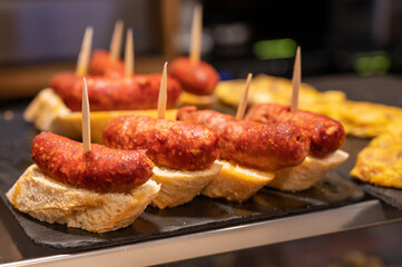 Typical snack is bars of Basque Country pinchos or pinxtos, small slices of bread upon which ingredient or mixture of ingredients is placed and fastened with toothpick, San Sebastian, Spain