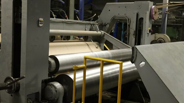 winding of a roll of technical paper on the timelapse paper mill line