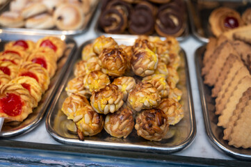 Variety of cookies and cakes on display in artisanal bakery in San Sebastian city, Basque Country, Spain