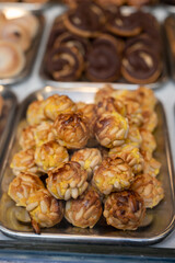 Variety of cookies and cakes on display in artisanal bakery in San Sebastian city, Basque Country, Spain