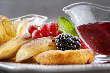 Cottage pancakes with berry jam, sour cream and berries.