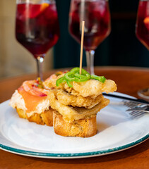 Food and drink in bars of Basque Country pinchos or pinxtos, small slices of bread with different...