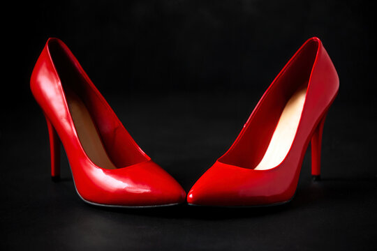 red women's shoes on a black background