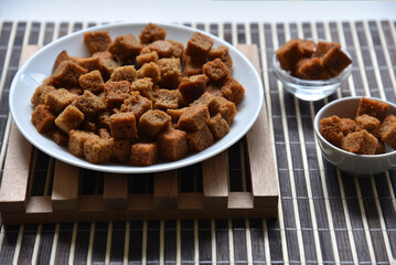 Spicy and spiced breadcrumbs on a white plate close-up.