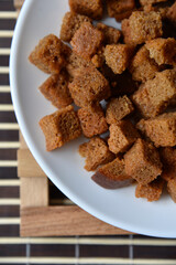 Spicy and spiced breadcrumbs on a white plate close-up.