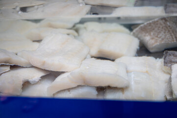 White salted and dried bacalao codfish is watertank, traditional Spanish food on display in fish shop
