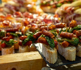 Typical snack of Basque Country and Navarre, pinchos or pinxtos, small piece of bread with different toppings, served in bar, Bilbao, Spain