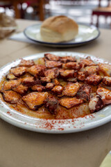 Tasty seafood, grilled octopus galician style with red pimento paprika and potatoes