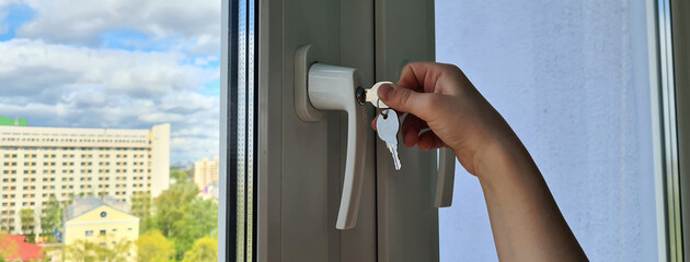 Small child opens window security lock with key