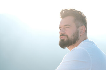 A handsome bearded man with beauty hairstyle deeply relaxing mind.	