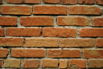 Fragment of a ceramic brick wall with white masonry mortar, white masonry seams, close-up