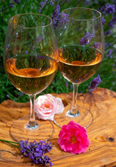 French rose wine from Provence, two glasses of wine with purple lavender flowers on background