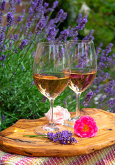 French rose wine from Provence, two glasses of wine with purple lavender flowers on background