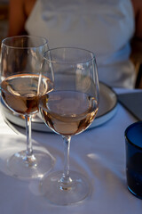 Dinner at sunset in French restaurant with cold dry rose wine in Port Grimaud, summer vacation on French Riviera, France