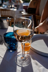 Dinner at sunset in French restaurant with cold dry rose wine in Port Grimaud, summer vacation on...