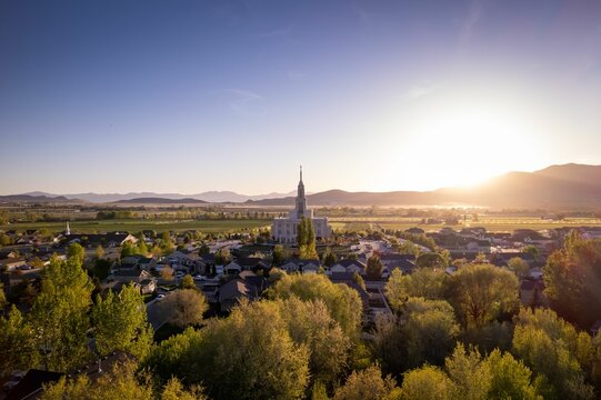 Aerial view of Payson Utah Temple in the middle of trees and houses under the blue sky