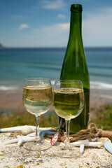 Tasting of txakoli or chacolí slightly sparkling very dry white wine produced in the Spanish Basque Country, served outdoor with view on Bay of Biscay, Atlantic Ocean.
