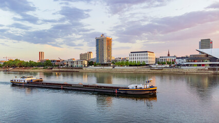 rhein-Galerie - boat in rhine river in evening sunset time Mannheim, Germany  - obrazy, fototapety, plakaty