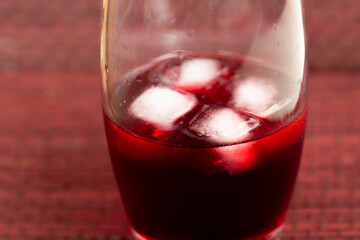 glass of red wine with ice