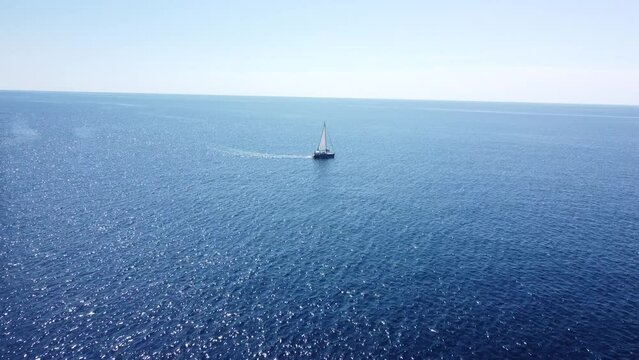 A boat peacefully sailing in blue sea and sunlight sparkling on the water surface, Zadar, Croatia