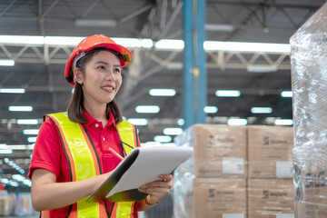 female worker checking inventory on shelves of distribution warehouse.  Storehouse employee in uniform. warehouse worker. logistics concept.