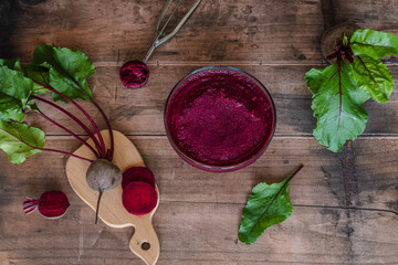Vegan beetroot homemade ice cream in a glass plate on a wooden table. top view. Recipe healthy...