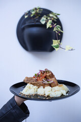 plate with meat and mashed potatoes with vegetables, pot with the bottom