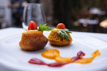 dish presented artistically on a plate with different sauces