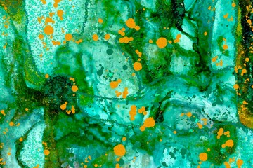 Gold drops on black and green Alcohol ink fluid abstract texture fluid art with gold glitter and liquid.