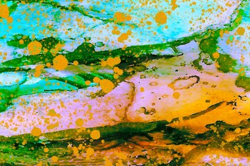 Gold drops on yellow and green Alcohol ink fluid abstract texture fluid art with gold glitter and liquid.