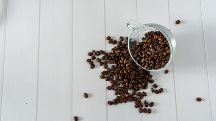 glass cup with coffee beans dropping down