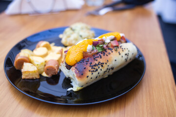 hot dog dish with different dressings and potatoes with sausages