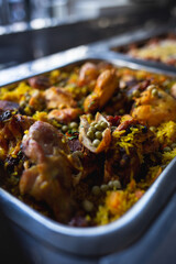 metal tray of a buffet with rice with chicken and vegetables